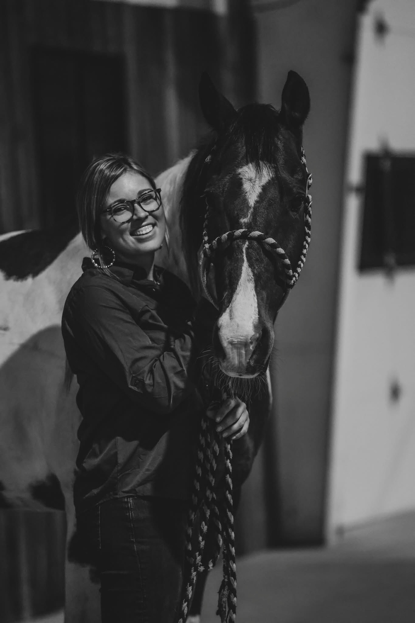 Madison standing beside her bay horse